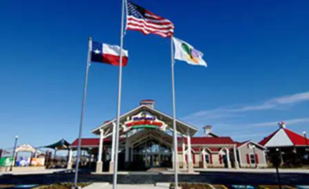 Three flags fly in front of the entrance to Morgan's Wonderland Park.