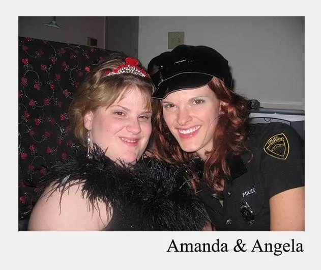Two smiling people, one in a police uniform and the other in a feather boa and tiara.