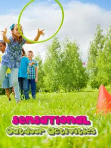 Children play ring toss in a grassy field.
