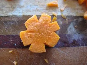 Carrot cut into a flower shape on a cutting board
