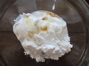 Coconut milk, powdered sugar, and vanilla extract in a bowl for a silly creature recipe.
