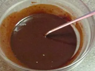 Melted chocolate in a bowl with a spoon.