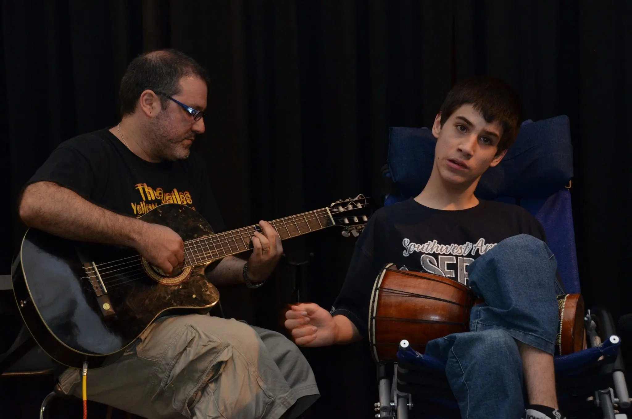 Gabriel Federico plays guitar with Matias, who holds a drum.