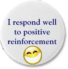 A round white badge with the text "I respond well to positive reinforcement" and a smiling emoji at the bottom.