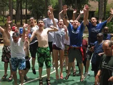 Group of people jumping in the air outdoors with excitement