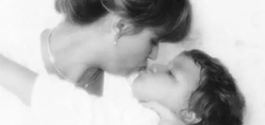 Mother and child sharing a tender moment with a kiss.