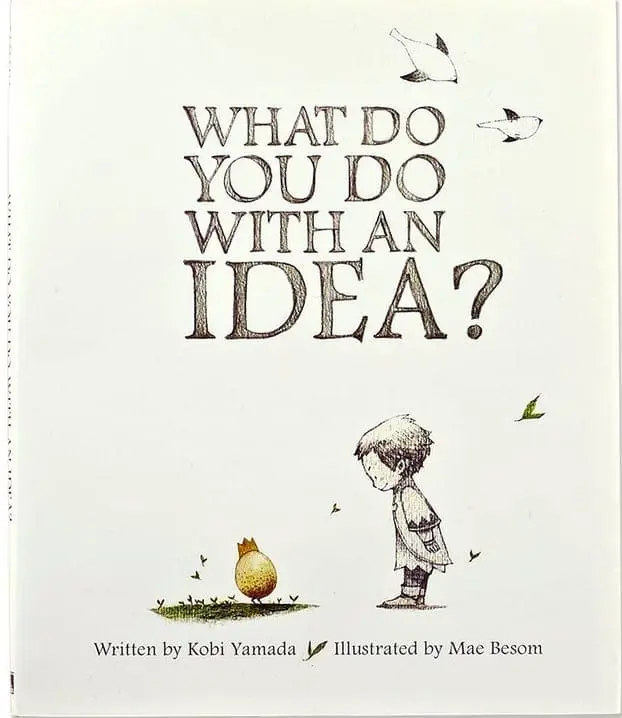 Book cover for "What Do You Do With An Idea?" featuring a boy and a pear-like creature.