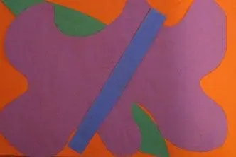 Purple paper cutouts resemble a flower on an orange background.