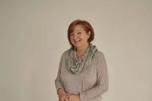 Annie Lachaud smiling with a scarf around her neck.