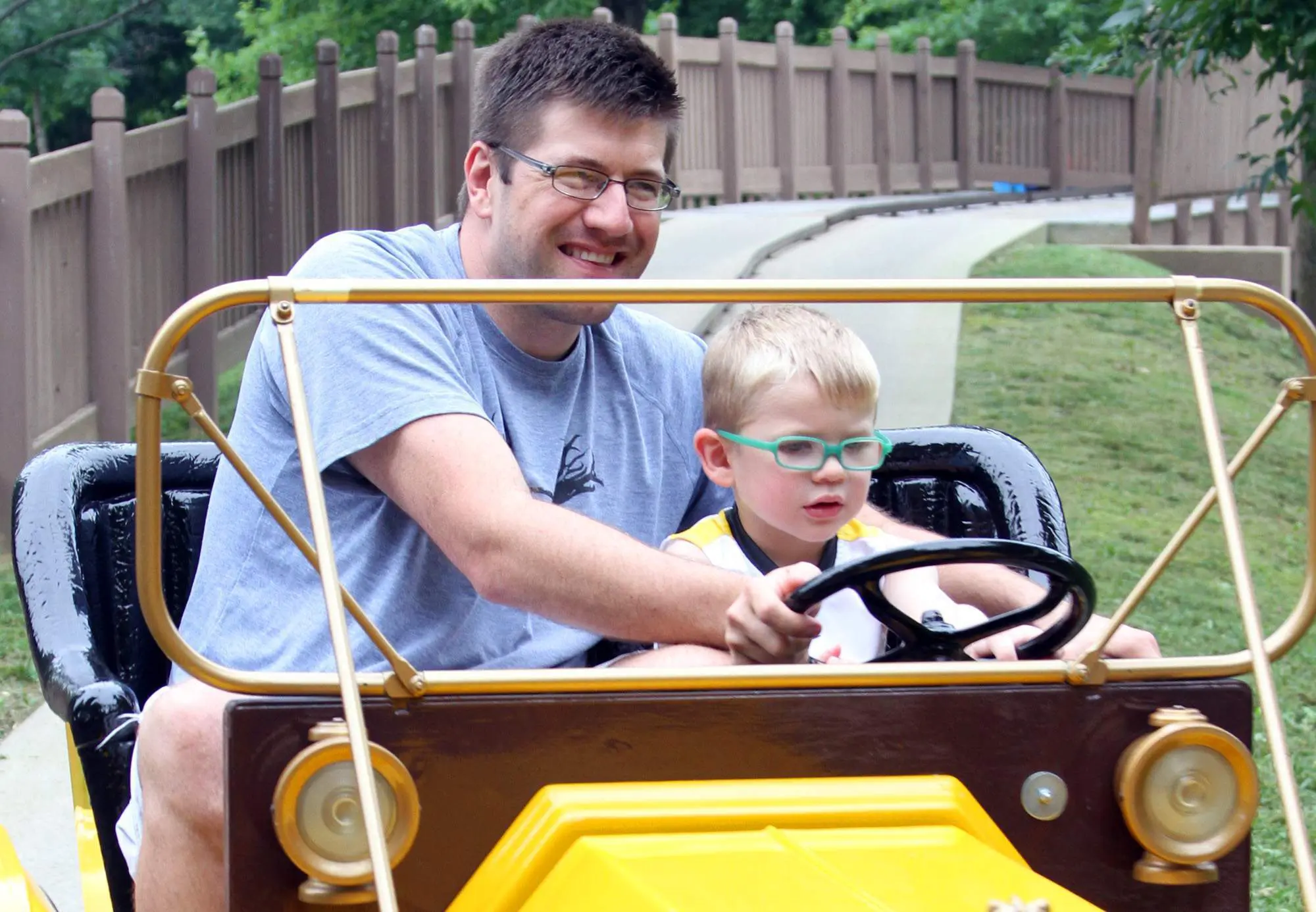 Man and boy in a toy car ride at Holiday World.