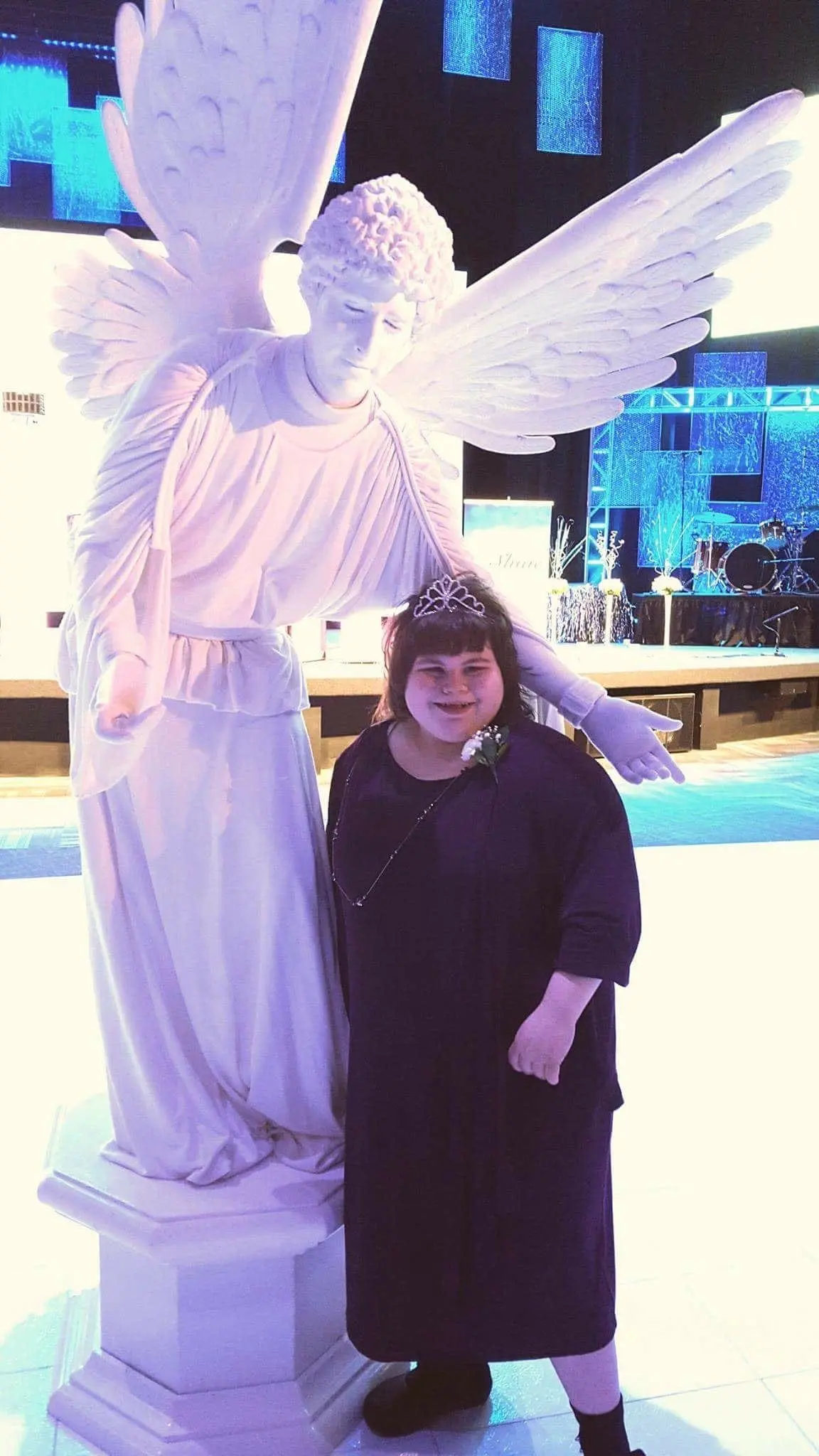 Ashley next to a statue of an angel.