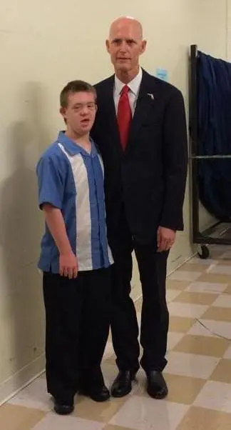 Matthew and a man in a suit and tie.
