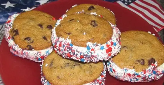 Ice cream sandwiches with red, white, and blue sprinkles on a red plate.