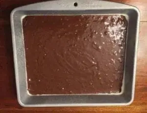 Brownie batter in a baking pan ready for the oven.