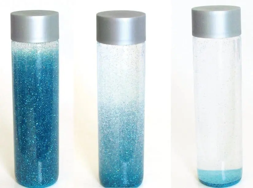 Three glitter bottles showing different stages of settling.