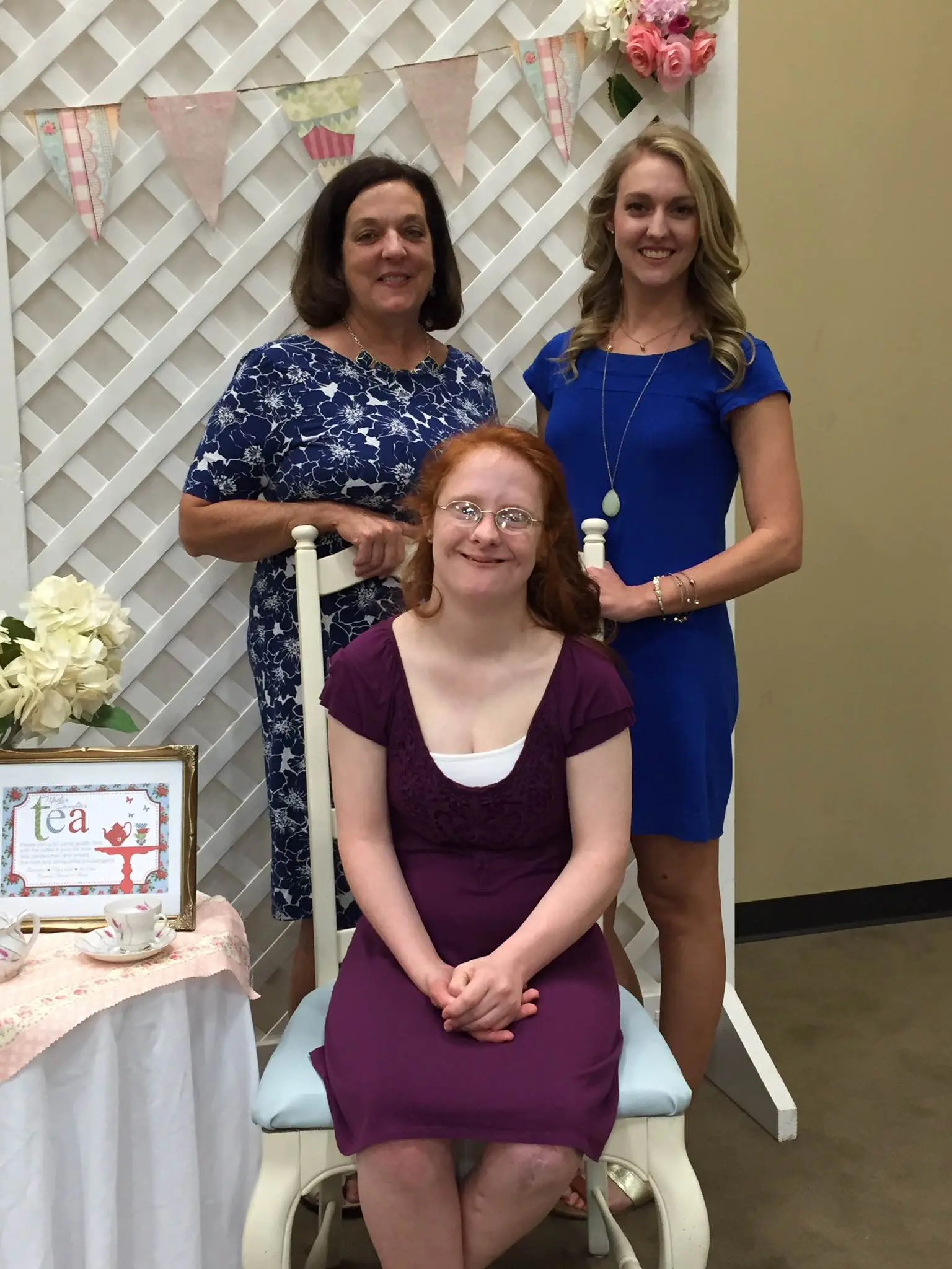 Kathy and her two daughters smile at the camera.