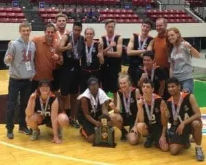 Unified Sports team posing with a trophy and medals.