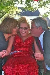 April Gray between two adults.