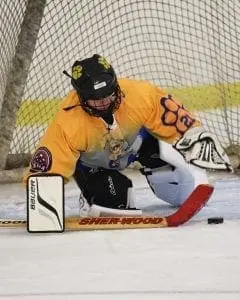 Cleveland Rockin' Wildcats goalie in uniform crouches by the net.