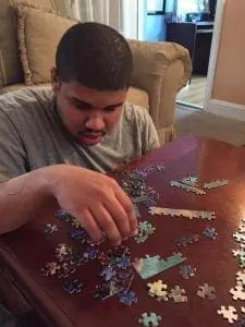 Sandy Charlot completing a puzzle.