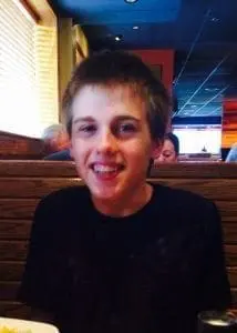 Sammy smiling in a restaurant.