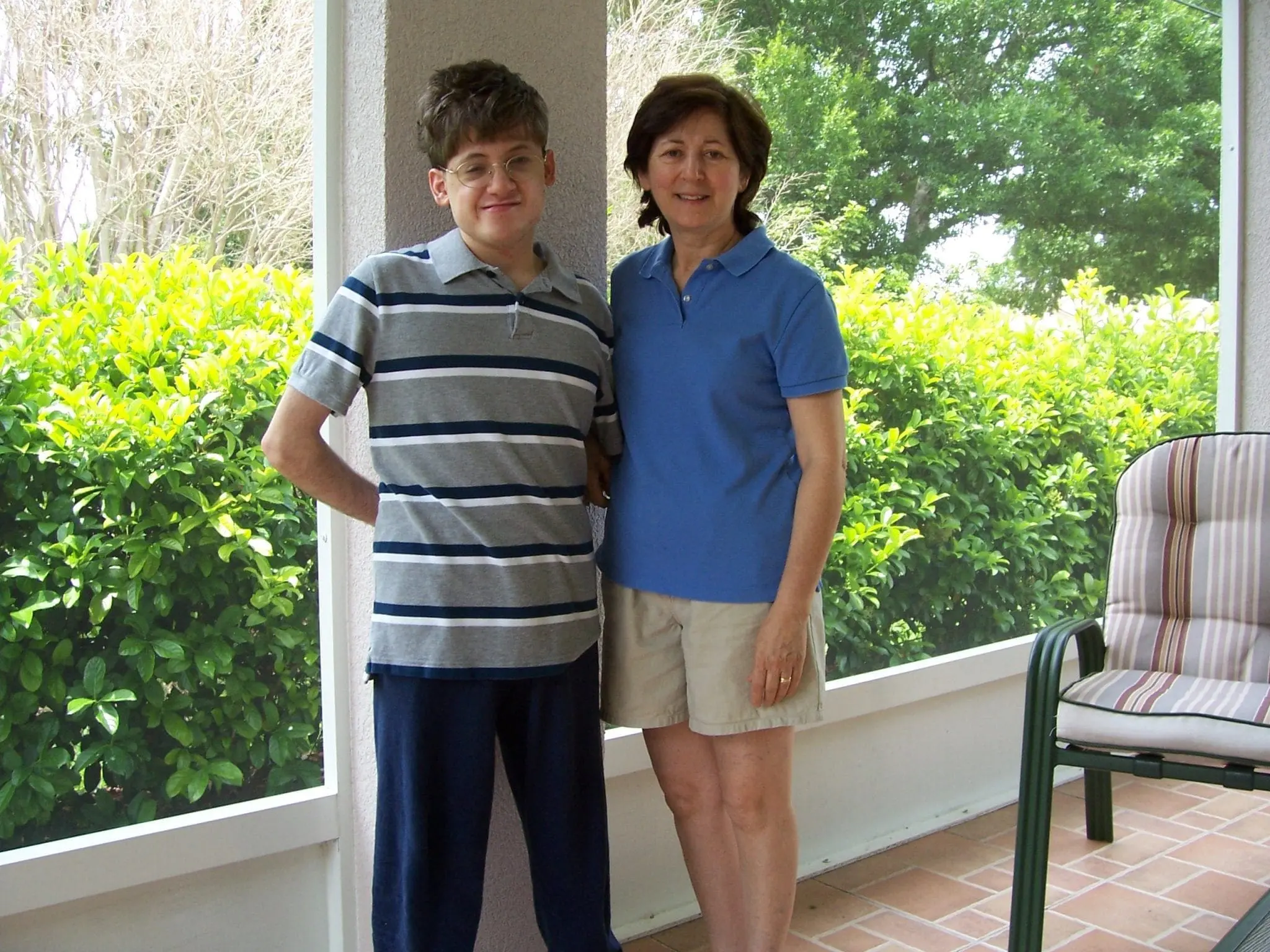Adam and Antoinette standing together on a porch.