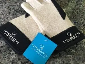 Pair of LatherMitts gloves with a blue tag on a speckled countertop.
