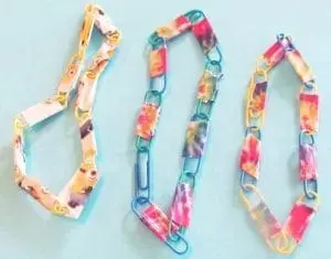 Paper clip bracelet and necklace made with colorful paper clips and fabric strips.