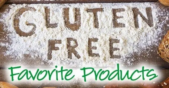 Gluten Free Favorite Products spelled out in flour on a wooden surface.