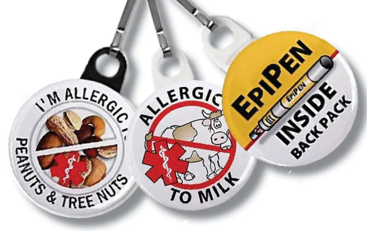Three allergy alert tags: one for peanuts and tree nuts, one for milk, and one for an EpiPen inside a backpack.