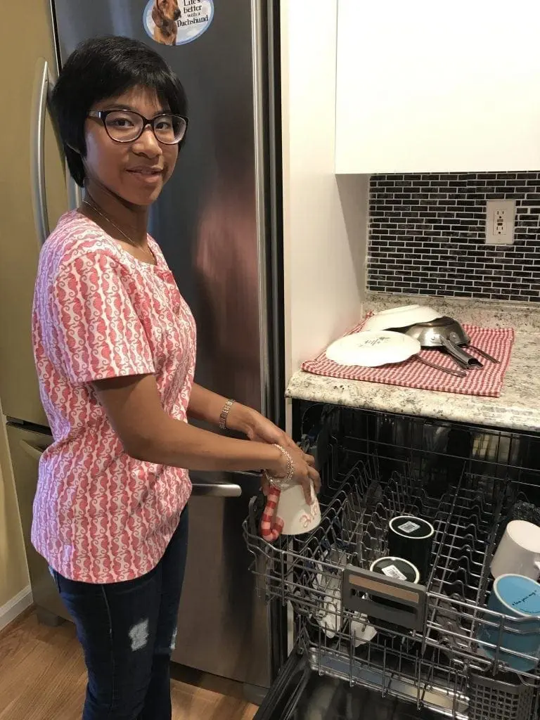 Stephanie loading the dishwasher.