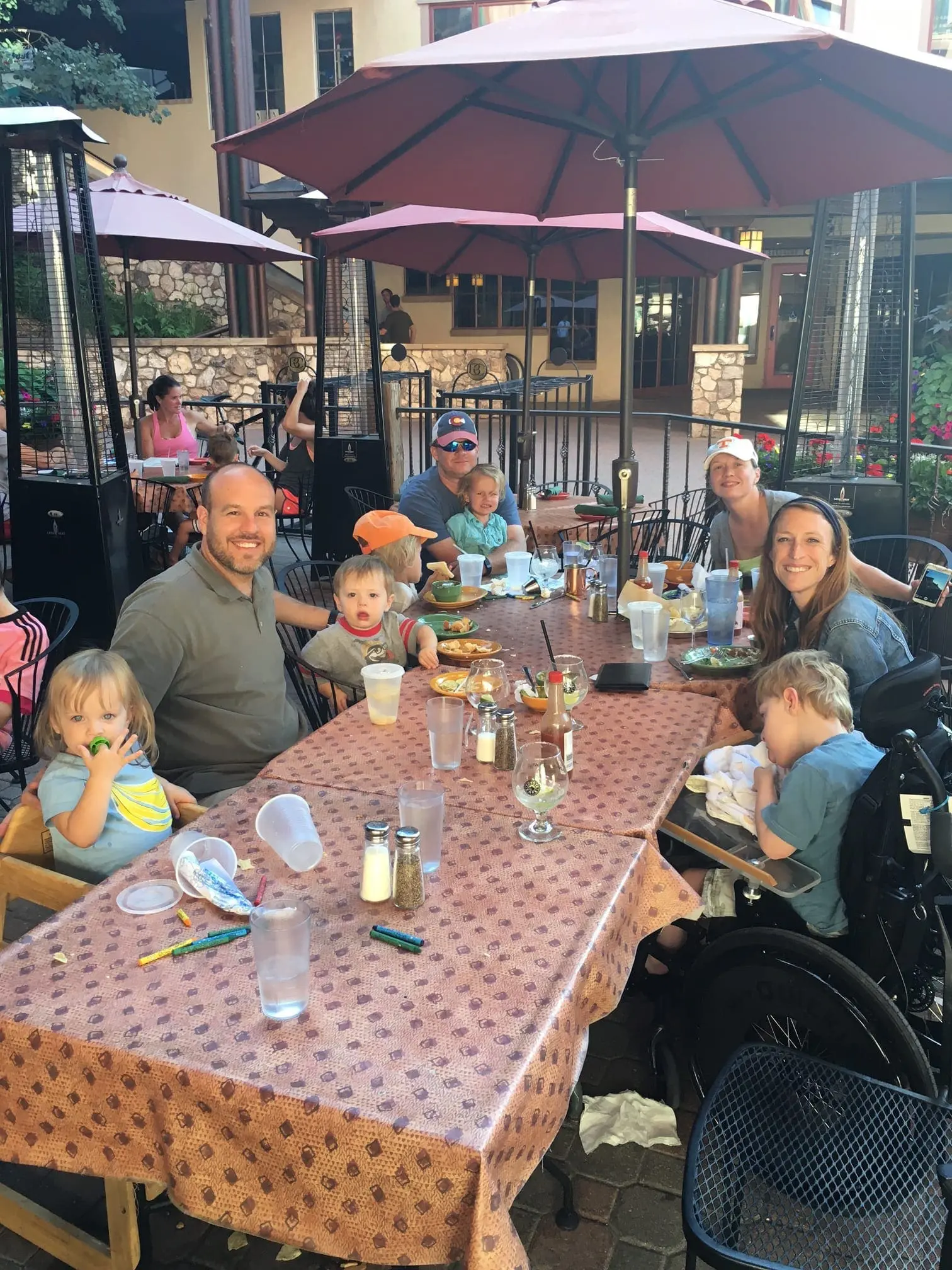 Family gathered around a table at an outdoor restaurant.