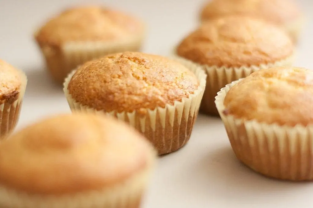 Several corn muffins in paper liners.