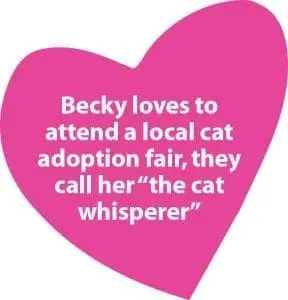 Pink heart with white text that reads "Becky loves to attend a local cat adoption fair, they call her 'the cat whisperer'".