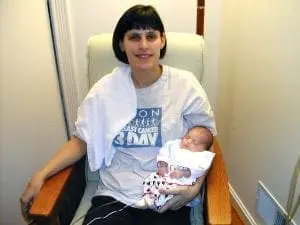Deb Discenza holding a newborn baby.