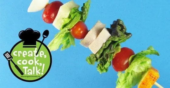 Kiddie Cobb on a stick with lettuce, tomato, cheese, and turkey on a blue background