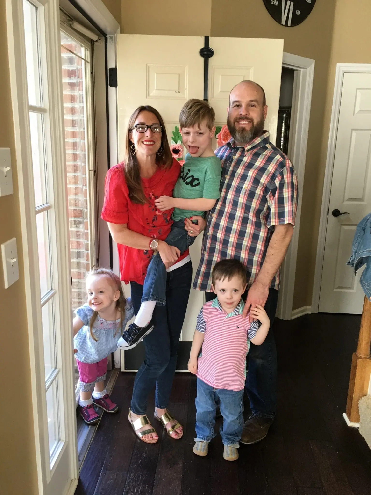 Family of five posing for a photo.