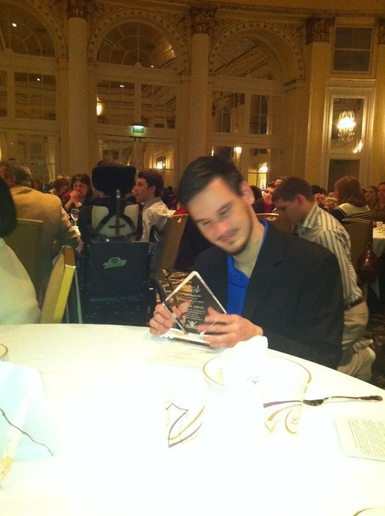 Jordan Obrecht looking at an award.
