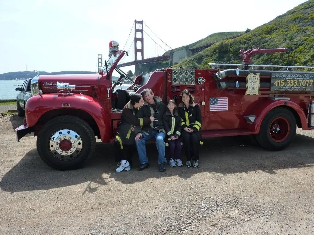 Julie Jones with her family in front of a fire truck.