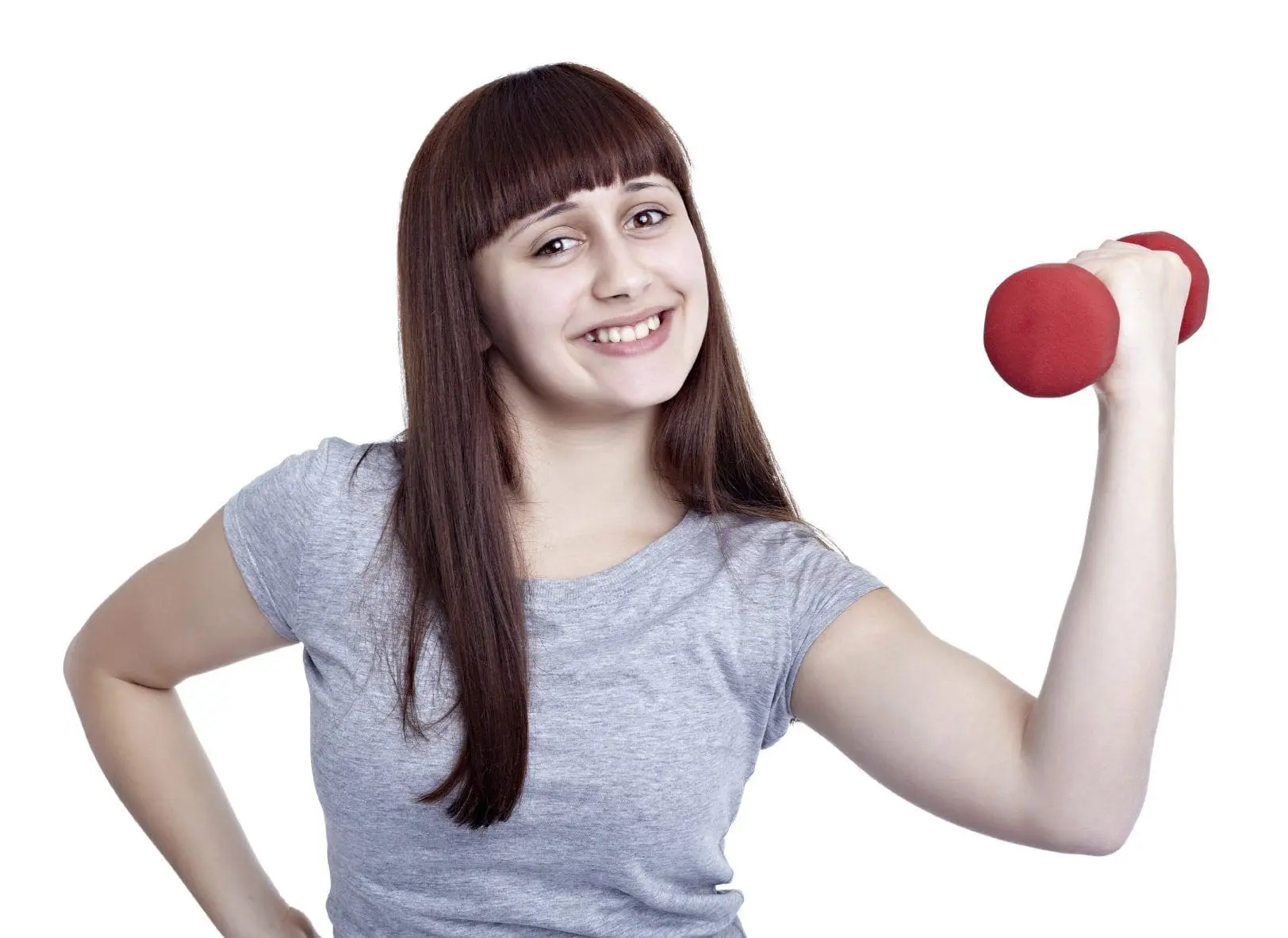 Young woman smiling while lifting a dumbbell