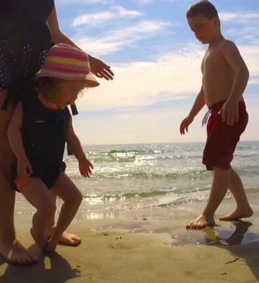 Willow Rose playing in the sand with her brother.