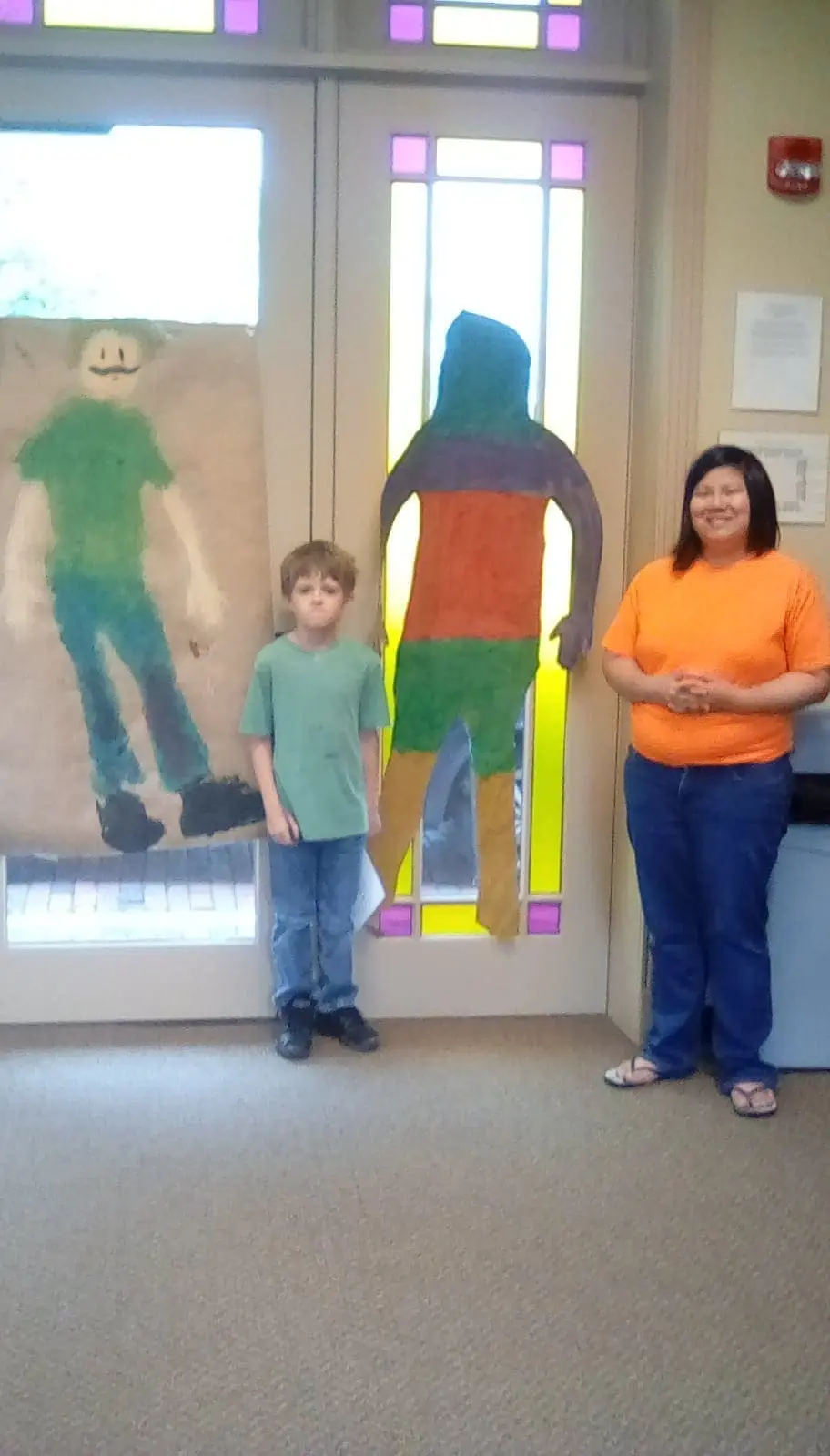 Charlie Faith with two colorful self-portraits and a woman.