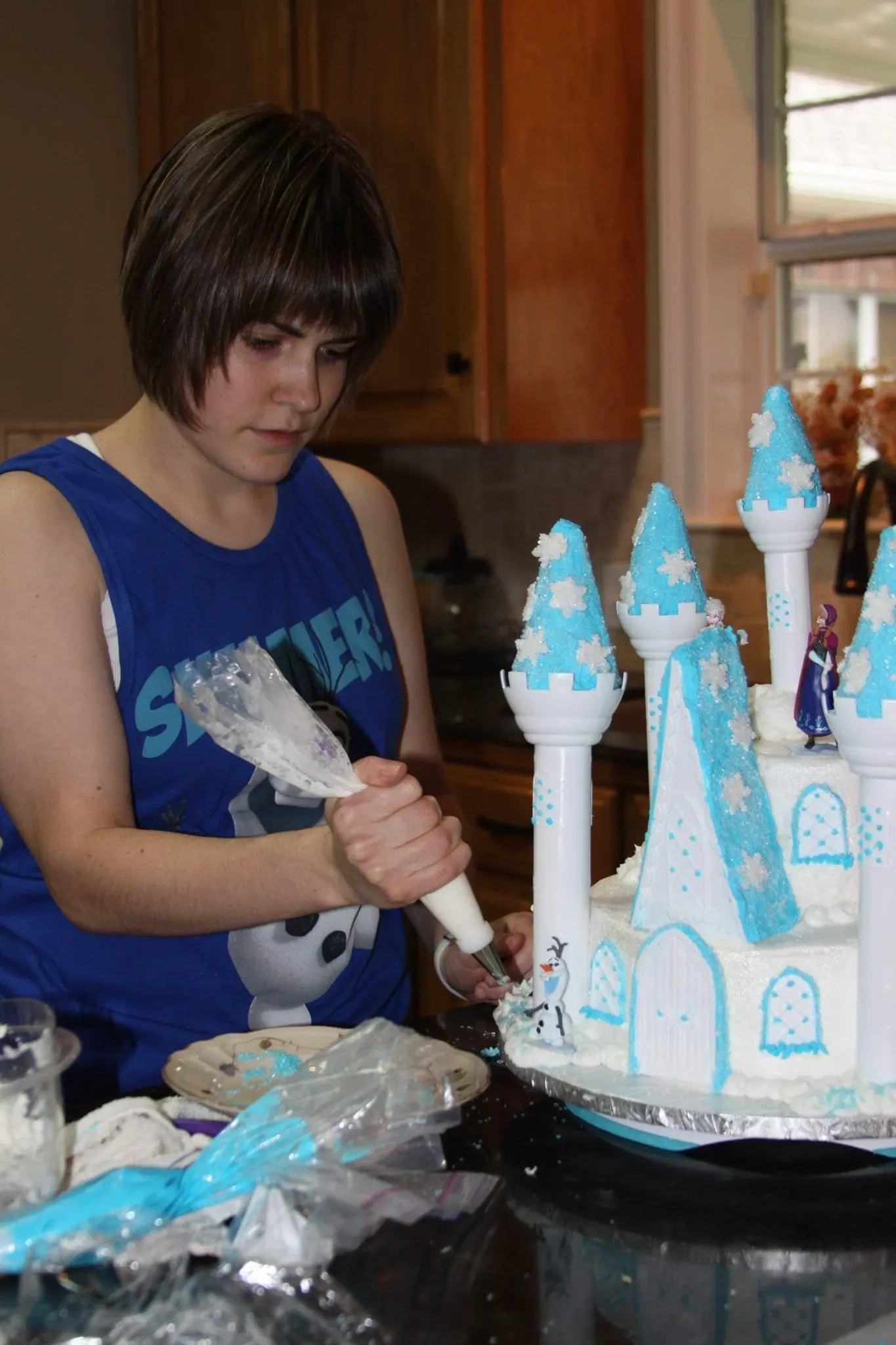 Charlotte Chapman decorating a castle cake.