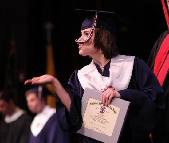 Allix Chapman in a graduation gown holding a diploma.