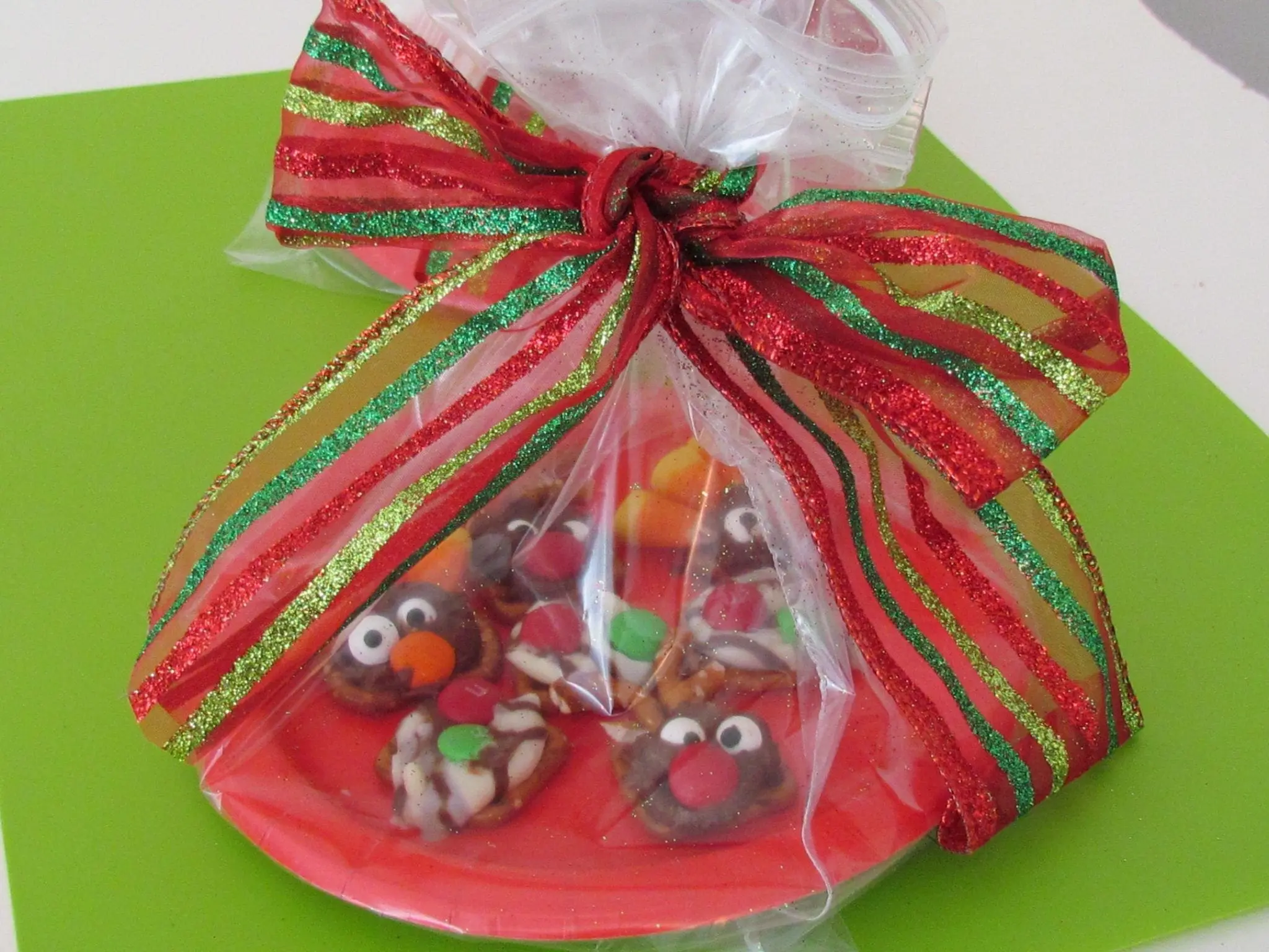 Holiday pretzel treats decorated like reindeer and turkeys, tied with a festive ribbon.