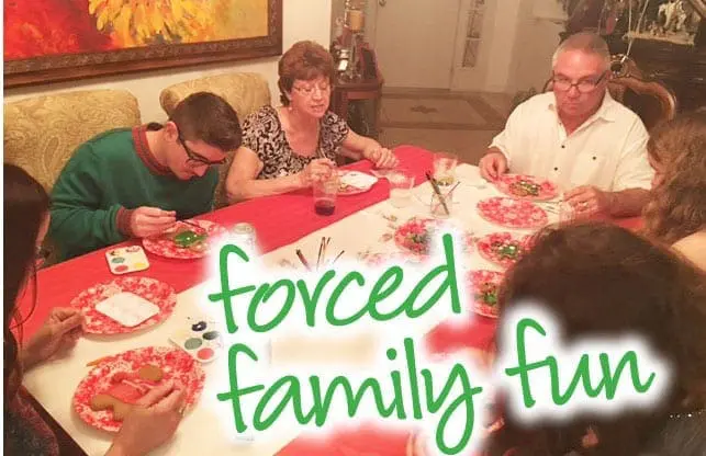Family members sit around a dinner table with "forced family fun" text overlaid.
