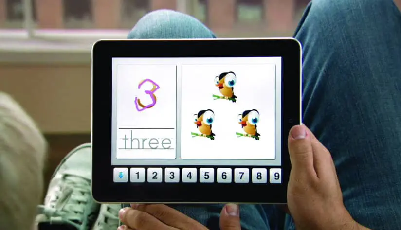 Tablet displaying the number three with three cartoon characters.