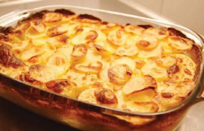 Scalloped potatoes in a glass baking dish.