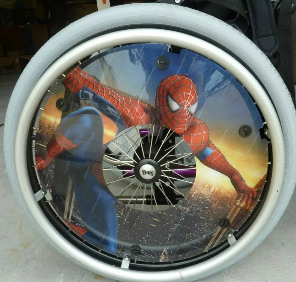 Spider-Man is depicted on the wheel of a wheelchair.