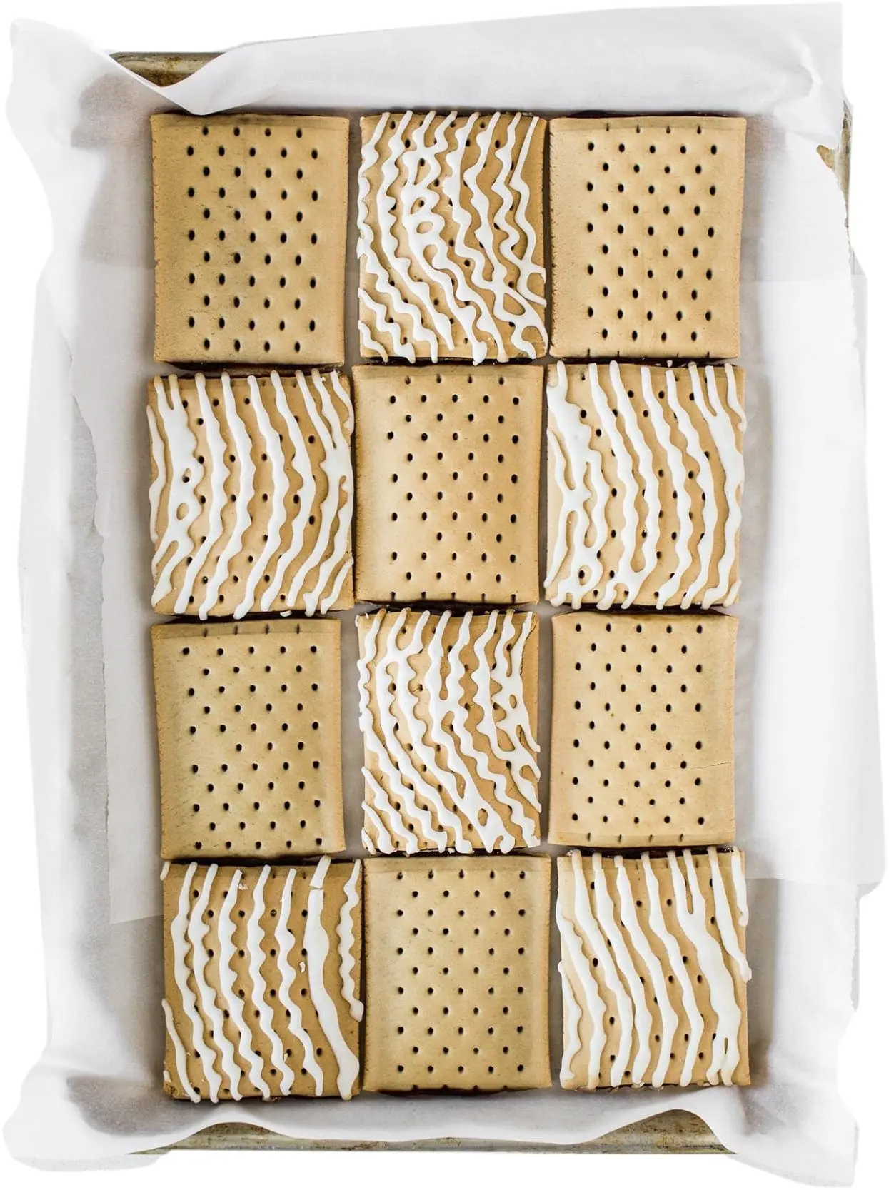 Tray of cookies with white icing drizzle
